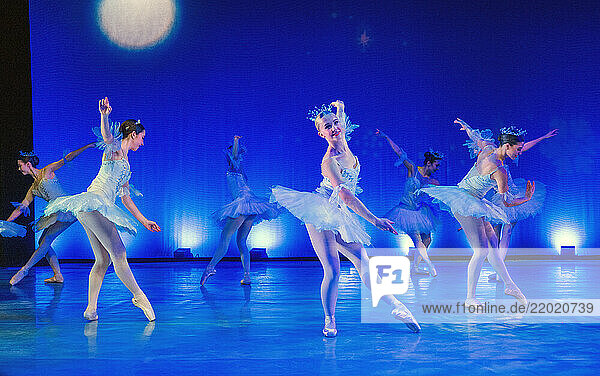 Ballet dancers in blue tutus performing a graceful dance under stage lights. The Nutcracker  Bainbridge Island  USA
