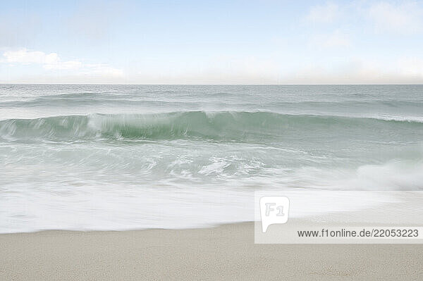 Ocean waves splashing om Tom Nevers Beach. long exposure