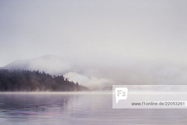 Morning mist rising over calm Lake Placid