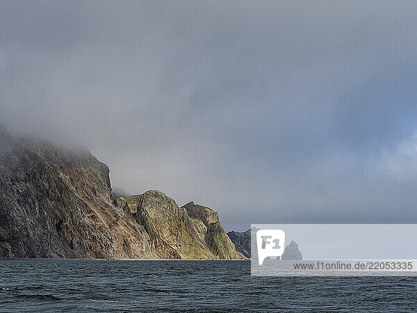 Storm clouds covering rocky coast