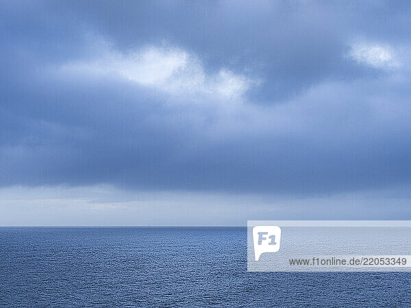 Storm clouds over calm sea