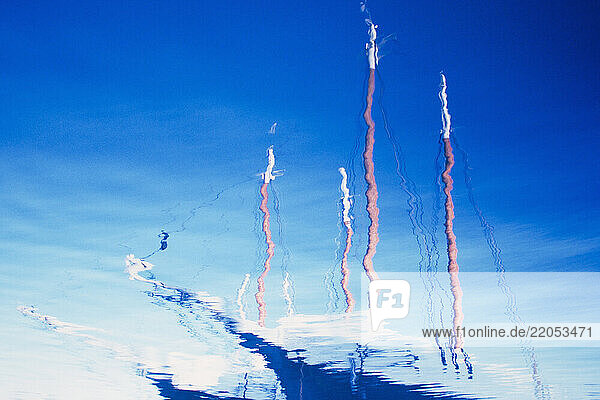 Sailboat reflected in blue rippled water