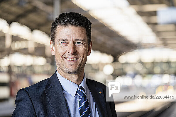 Portrait of smiling businessman at station platform