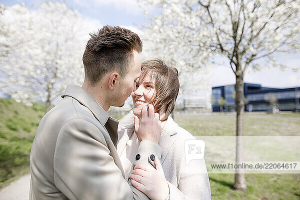 Affectionate couple strolling in a park in spring