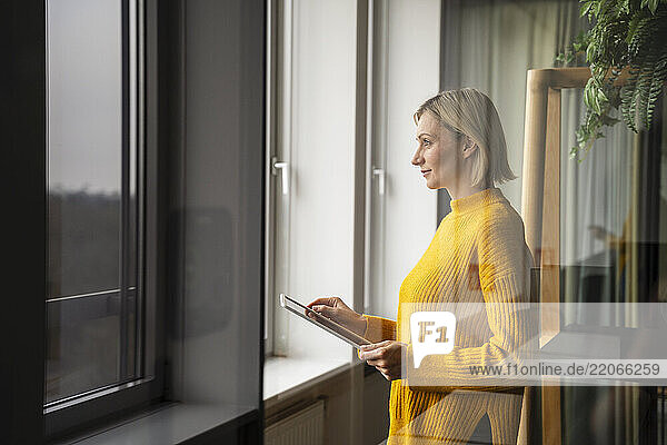 Businesswoman in a modern office using a tablet