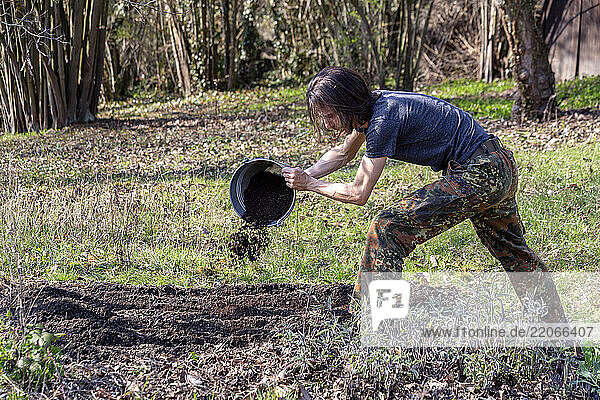 A skilled farmer using a wooden plough to prepare the field for planting crops with precision and expertise
