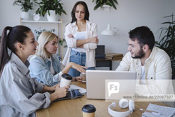 Businesswoman discussing strategy with coworker in meeting room at office