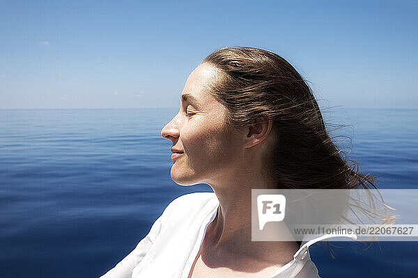 Seychelles  Indian Ocean  profile of woman on ferry enjoying breeze