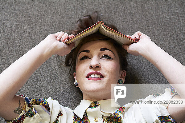 Female student reading book in a public library
