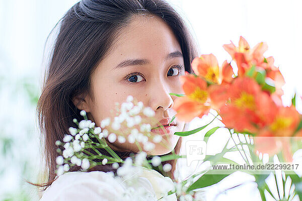 Japanese Woman Holding A Bouquet Of Flowers
