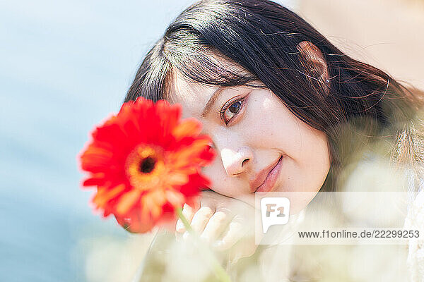 Japanese Woman Looking At A Flower