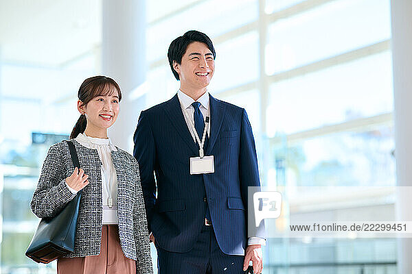 Japanese Businesspeople Talking In Lobby