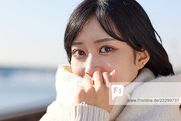 Japanese Woman In A White Coat Looking At Camera