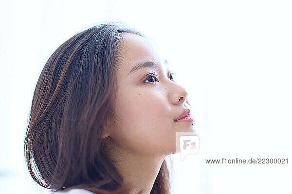 Japanese Woman Looking Up At The Sky With Her Eyes Closed