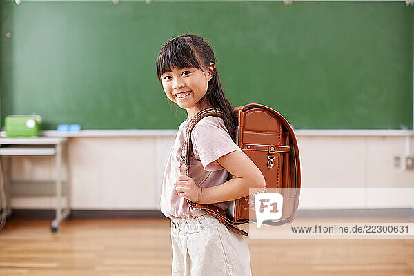 Japanese Girl Standing In Front Of A Chalkboard