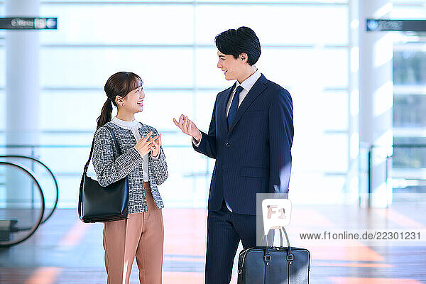 Japanese Business Couple Talking In The Airport