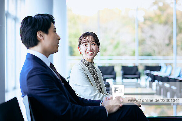 Japanese Businesspeople Sitting In An Office