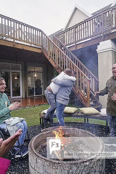 Disabled friends around fire pit