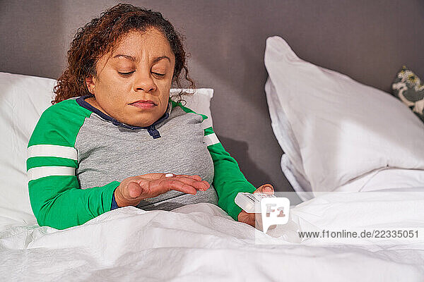 Disabled woman sitting in bed