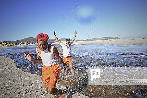 Gay couple playing in sea