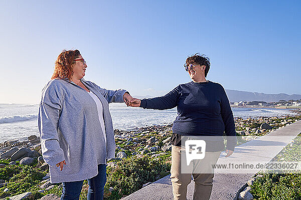 Lesbian couple walking on footpath