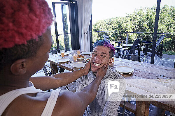 Smiling gay couple at home