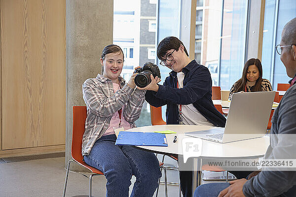 Man and teenage girl with Down Syndrome at photography class