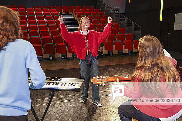 Friends playing and singing during rehearsal