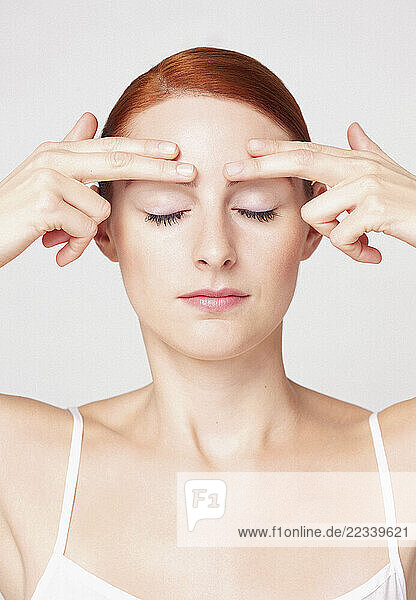 Woman with Fingertips on Eyebrows