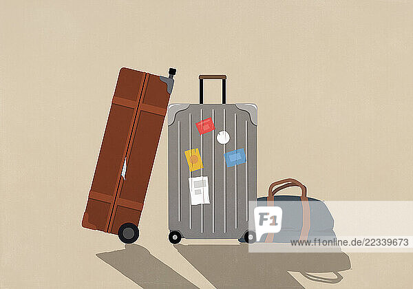 Luggage with travel stickers on beige background
