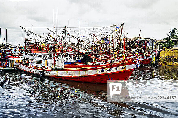 Long-tail boats along the shoreline in Phuket Province  Thailand; Phuket  Thailand