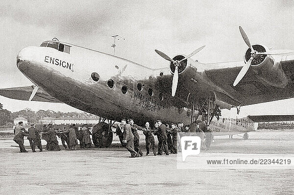 EDITORIAL An Imperial Airways Ensign being moved on to the runway by ground staff of the R.A.F. 1938. From Wings of War  published 1942.