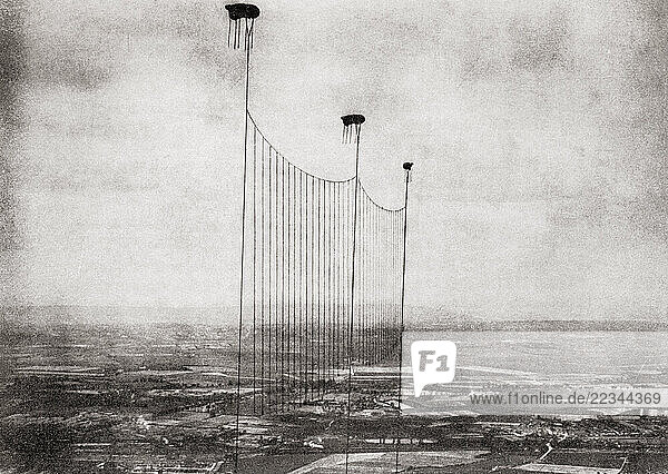 EDITORIAL A Balloon Apron used in the defence of London during WWI. Consisting of three balloons  500 yards apart  joined together by a heavy steel cable  enemy aircraft were forced to fly higher  which reduced their effectiveness as bombers. From Wings of War  published 1942.