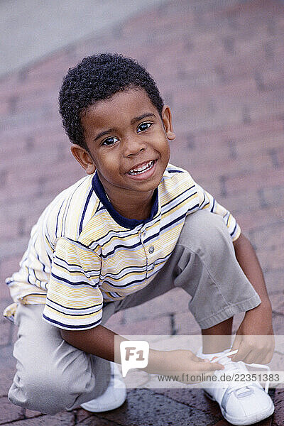 Child Tying his Shoe