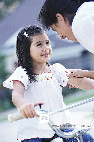 Mother Talking to Daughter on Bike