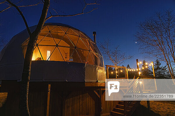 Nightime view of a geodosic dome with a moon in the night sky; Elderbank  Nova Scotia  Canada