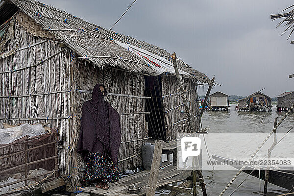 Houses flooded with high tide salt water at the Kalabogi village in Khulna  Bangladesh  on 31 August 2023. In the coastal areas of Southern Bangladesh like Kalabogi  people‘s livelihoods depend entirely on nature. Climate change has severe impacts on the natural environment. The consequences range from rising sea levels leading to salinization of soils and groundwater to erratic rainfall patterns and more frequent and destructive tropical cyclones. People living in coastal areas fight for their survival every day; Khulna  Dhaka  Bangladesh