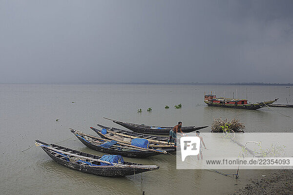 Fisherman is preparing to go inside the Sunderban forest for fishing at the Kalabogi village in Khulna  Bangladesh  on 01 September 2023. In the coastal areas of Southern Bangladesh like Kalabogi  people‘s livelihoods depend entirely on nature. Climate change has severe impacts on the natural environment. The consequences range from rising sea levels leading to salinization of soils and groundwater to erratic rainfall patterns and more frequent and destructive tropical cyclones. People living in coastal areas fight for their survival every day; Khulna  Dhaka  Bangladesh