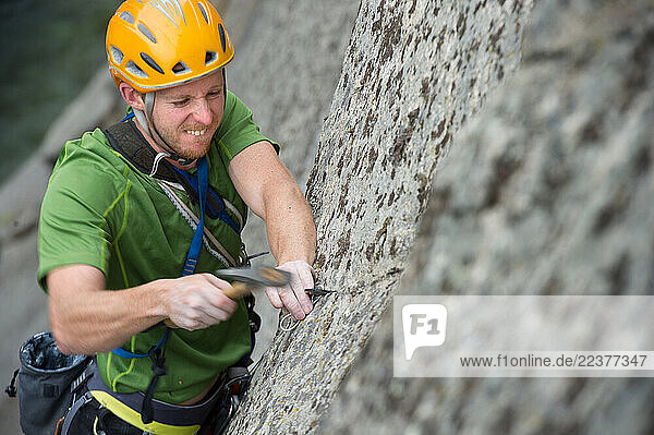 Tommy Caldwell place a piton on The Divine Bell route in Keketuohai National Geological Park  China.