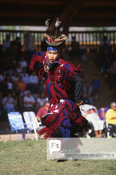 Native in ornate regalia.