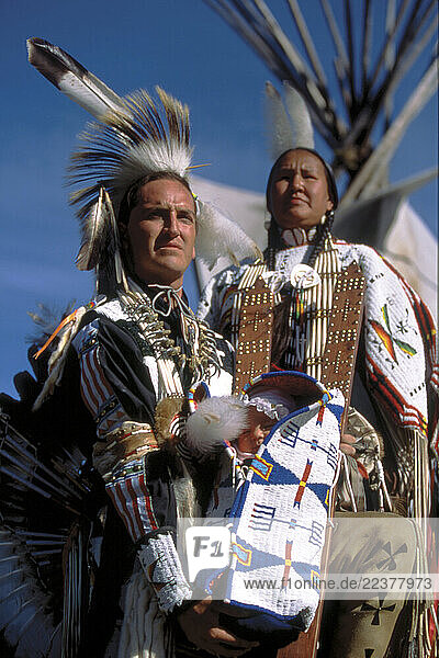 The Littlesky family poses outside a teepee.