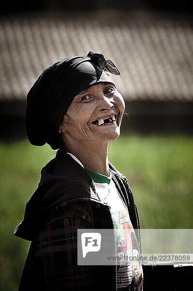 A local women laughing in a field. East Java  Indonesia.