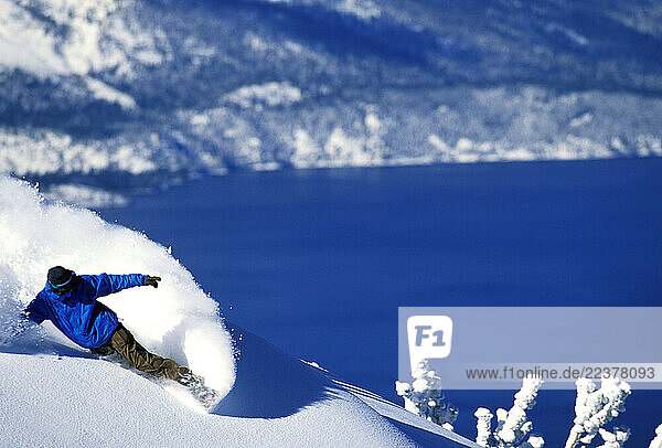 Mikey Wier carves as he snowboards at Heavenly Mountain Resort in Lake Tahoe. Heavenly is unique in that it is the only resort in Lake Tahoe to offer runs on both the California and Nevada sides.