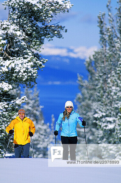 Cory Hall and Kim Miller cross-country ski at Heavenly Mountain Resort in Lake Tahoe. Heavenly is unique in that it is the only resort in Lake Tahoe to offer runs on both the California and Nevada sides.