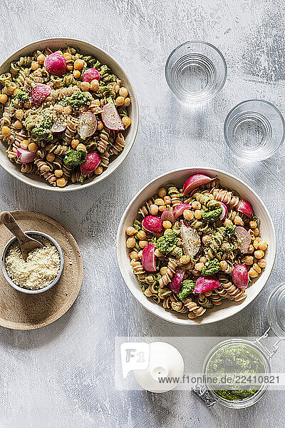 Vegan pasta with radishes  chickpeas  and pesto in a studio setting