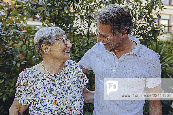 Happy mother and adult son in he garden