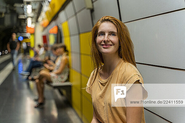 Portrait of smiling woman at underground station