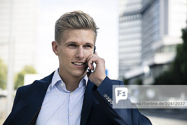 Young man talking on the phone in the city