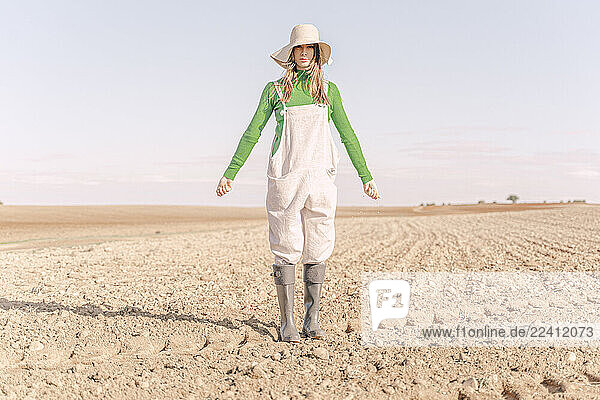Young woman sowing field for the future