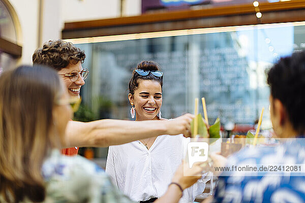 Happy multi-ethnic friends toasting drinks
